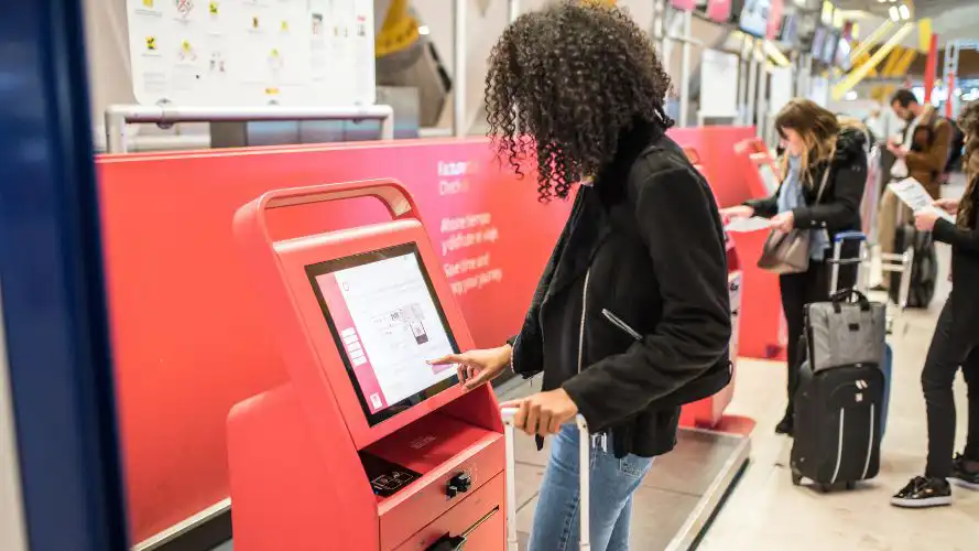 Woman using a kiosk at an airport